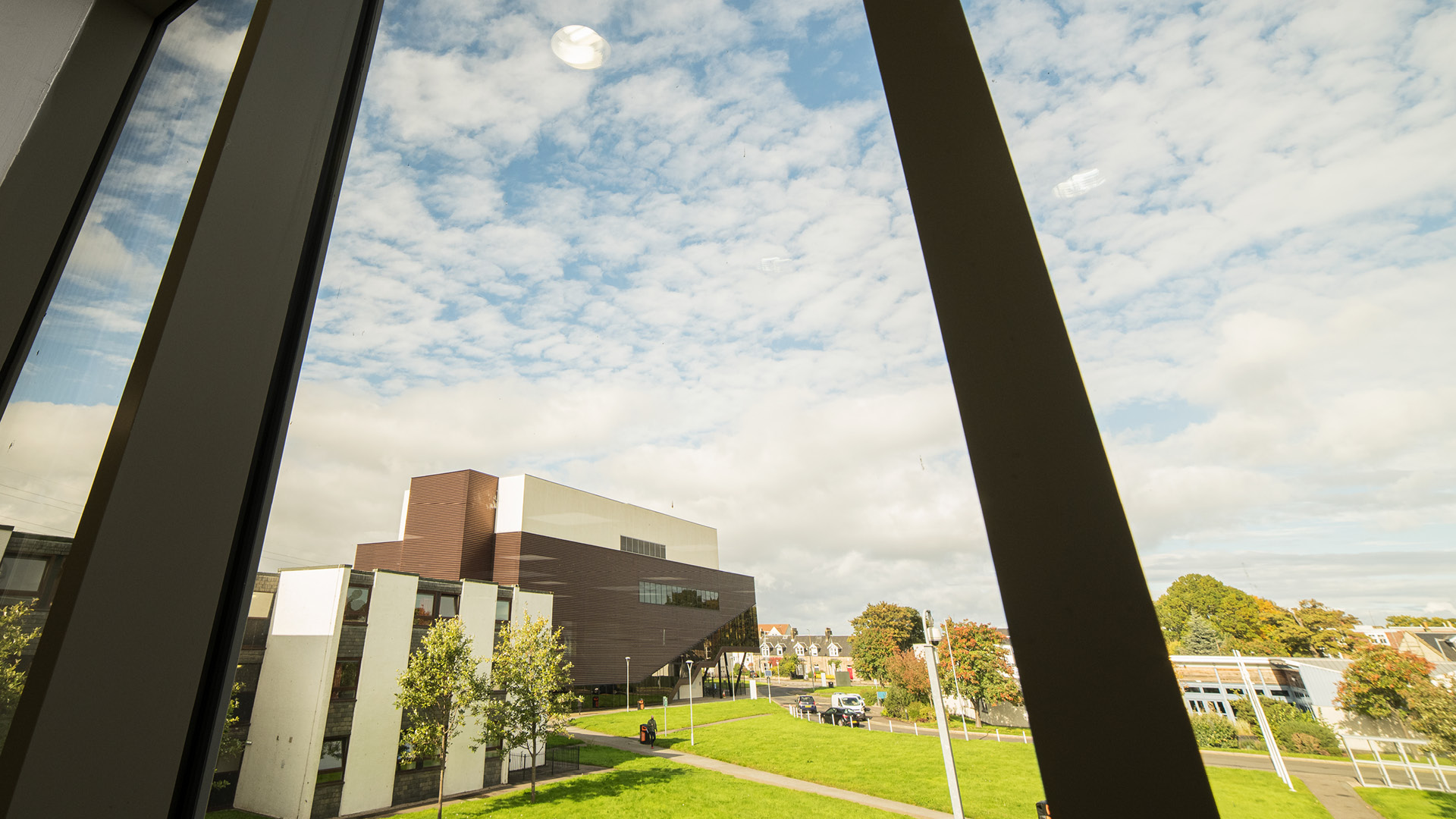 Looking out a window on a sunny day at Milton Road campus.