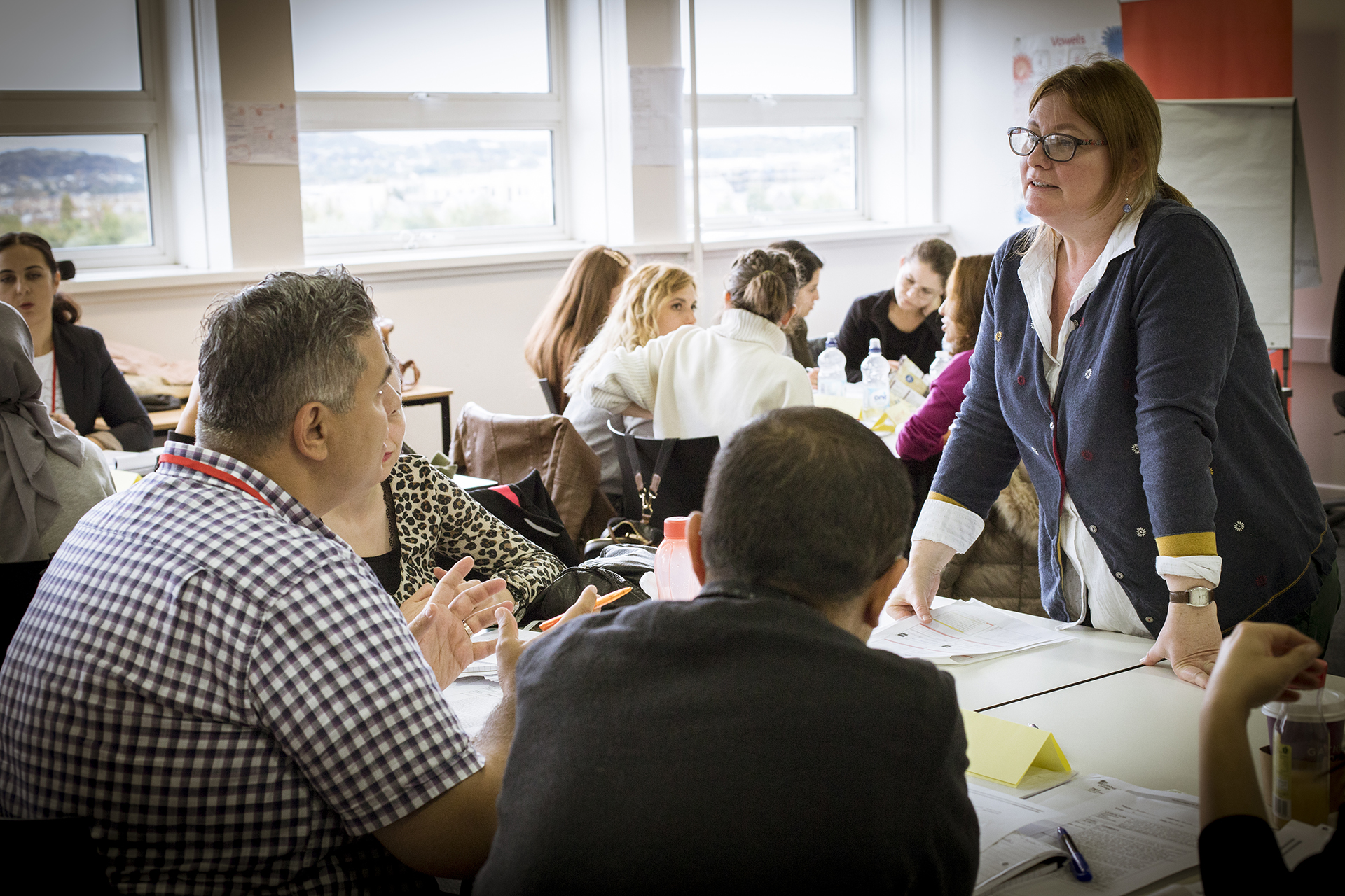 Lecturer helping a group of students studying together.